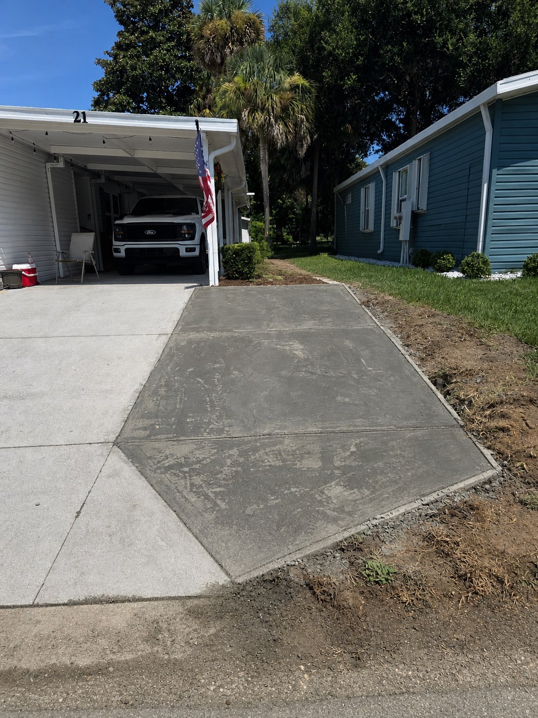 Finished concrete driveway extension viewed from the street