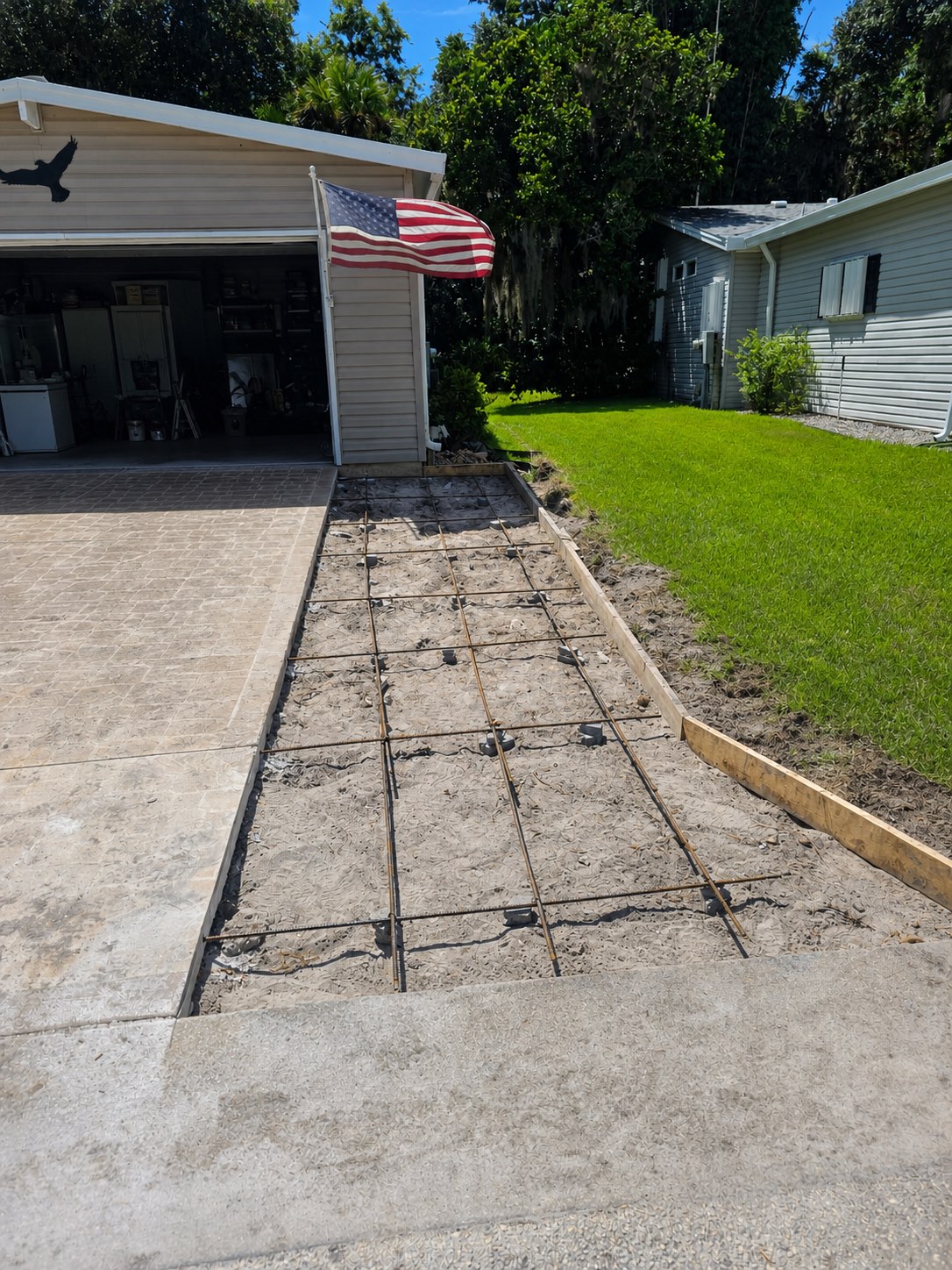 Driveway extension formed with supported rebar and ready for concrete