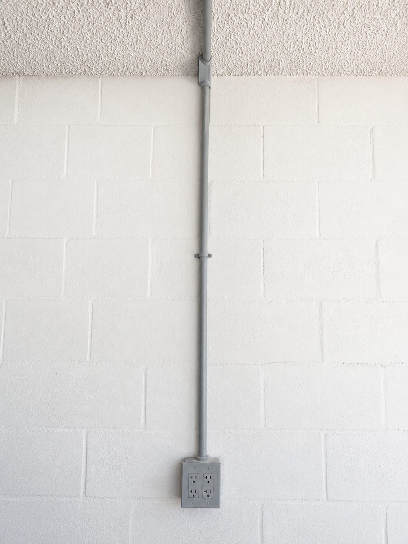 New duplex garage outlets with surface-mount conduit run from the panel
